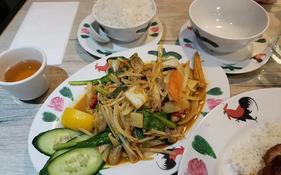 Mixed vegetables in a light curry sauce, served with rice and cucumber.