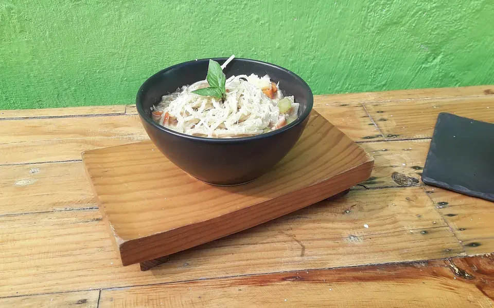 A bowl of minestrone thick with beans, carrot and pasta.