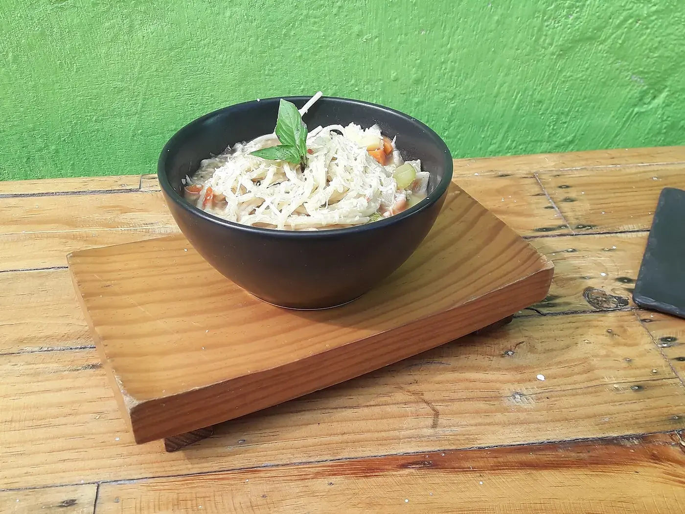 A bowl of minestrone thick with beans, carrot and pasta.