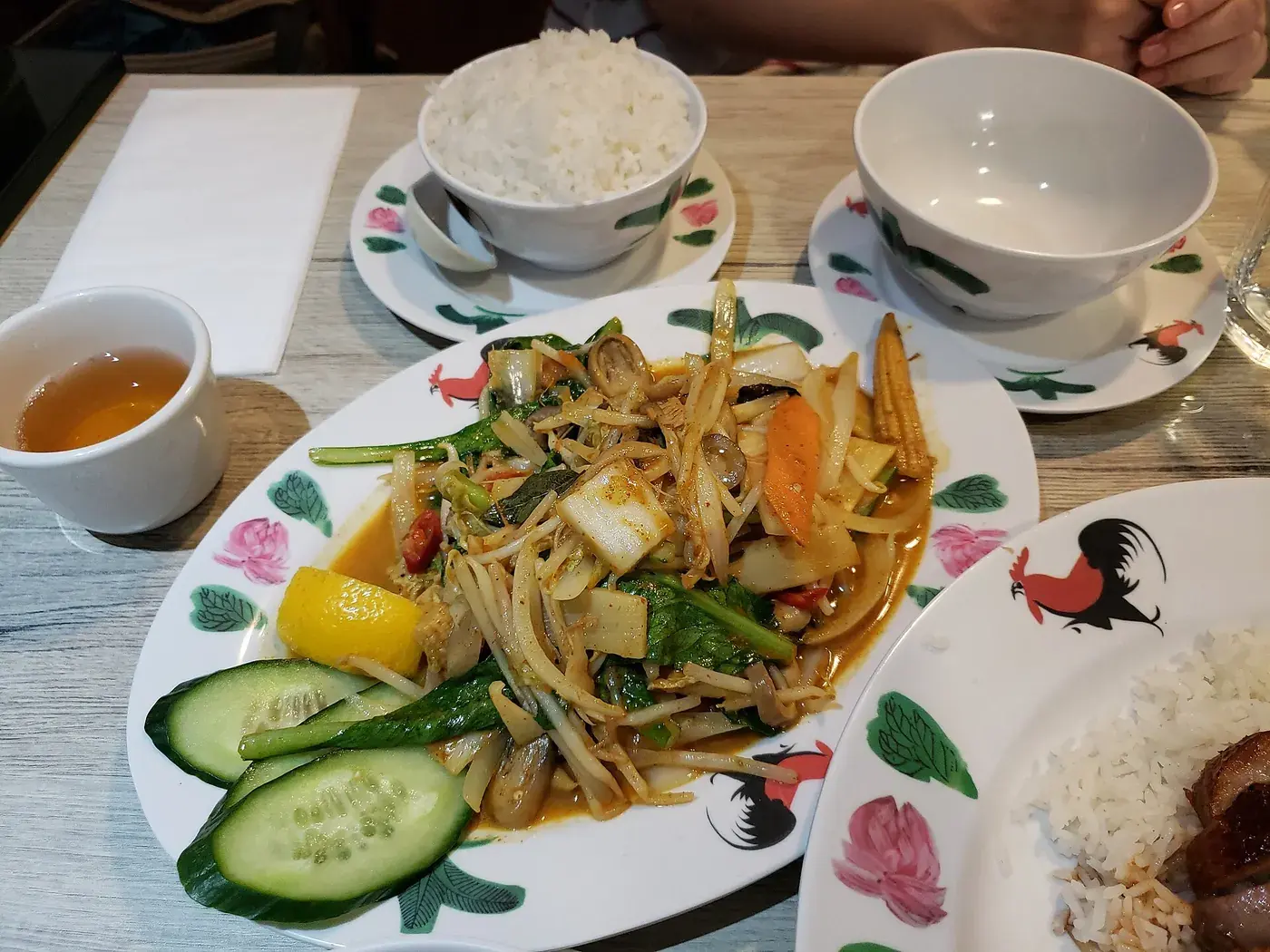 Mixed vegetables in a light curry sauce, served with rice and cucumber.